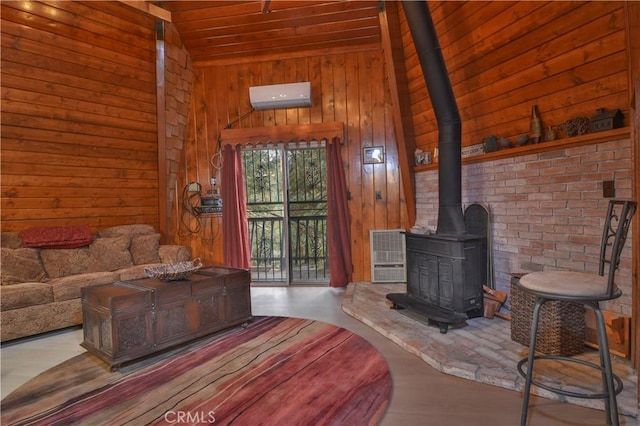 living room featuring a wall mounted air conditioner, a wood stove, wooden walls, vaulted ceiling, and wood ceiling