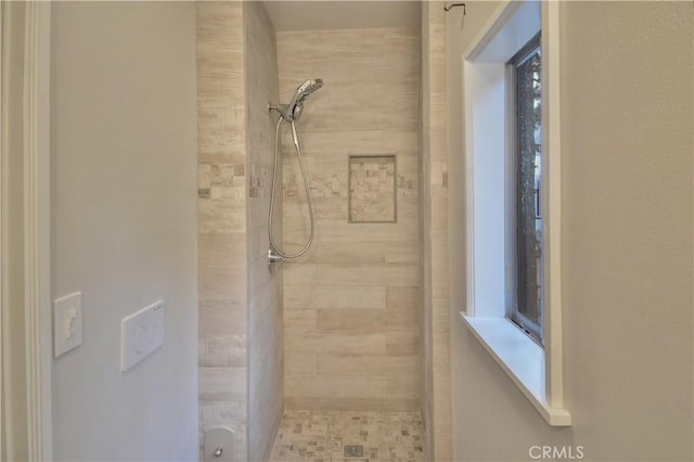 bathroom with tiled shower