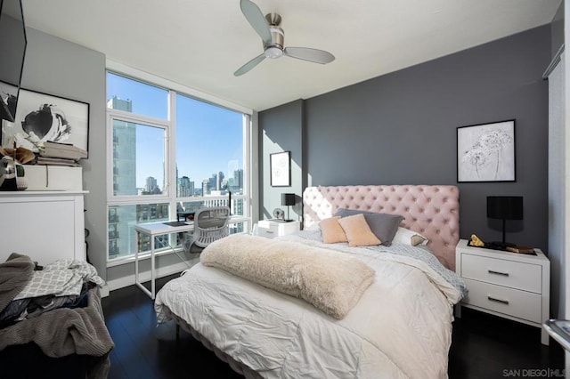 bedroom with dark hardwood / wood-style floors and ceiling fan