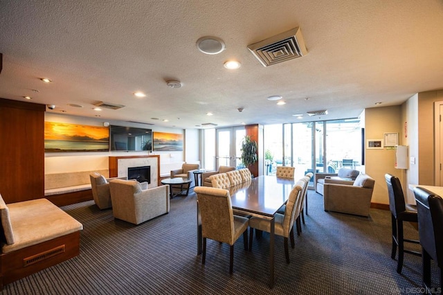 dining room with dark colored carpet, floor to ceiling windows, and a textured ceiling