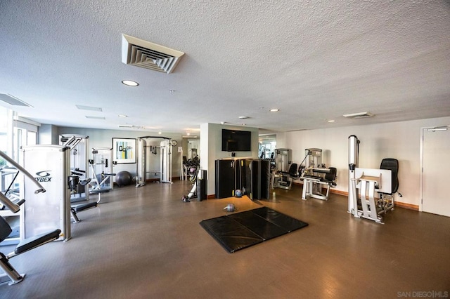 gym featuring a textured ceiling