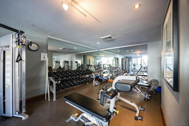 exercise room featuring a textured ceiling