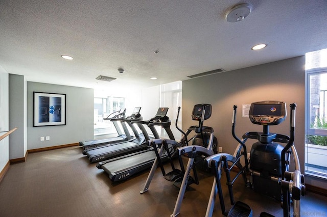 exercise room with a textured ceiling