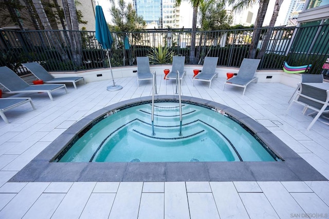 view of swimming pool with a patio area and a community hot tub