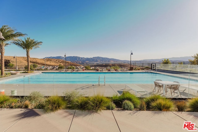 view of swimming pool with a mountain view