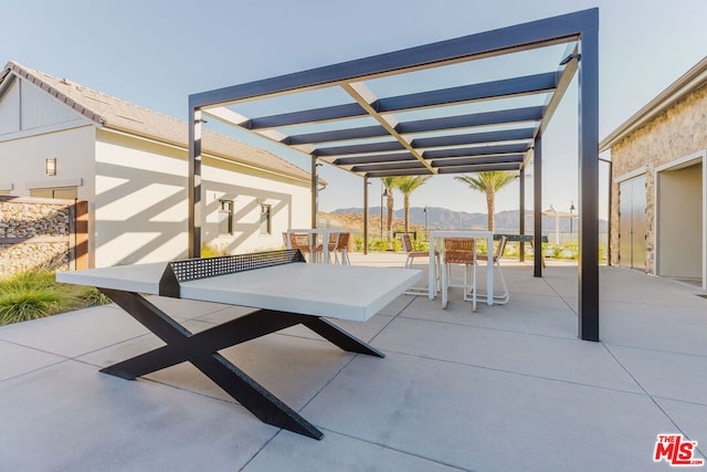 view of patio / terrace featuring a mountain view and a pergola