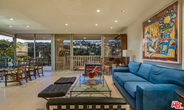 tiled living room featuring a wall of windows