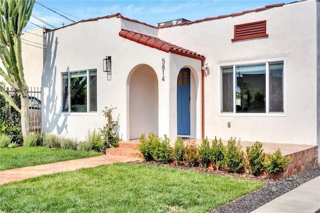 mediterranean / spanish-style house with a front lawn