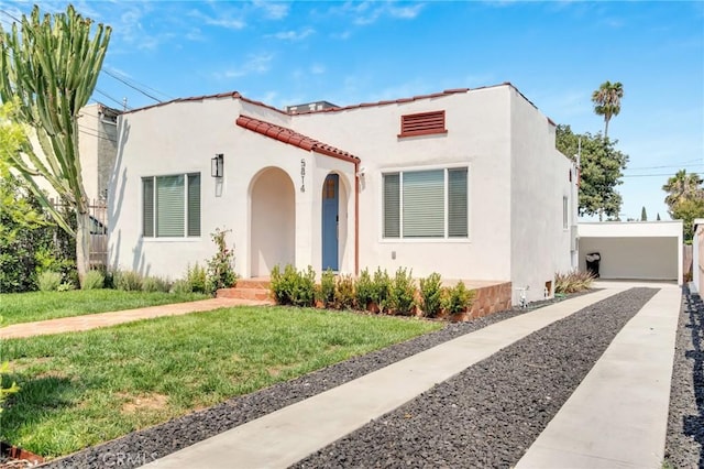 mediterranean / spanish-style home featuring a front yard