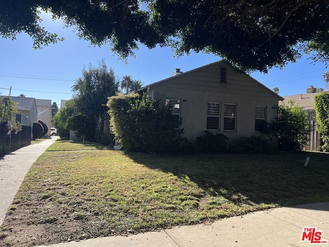 view of side of home featuring a lawn