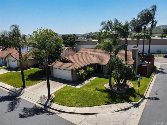 view of front of house with a garage and a front lawn