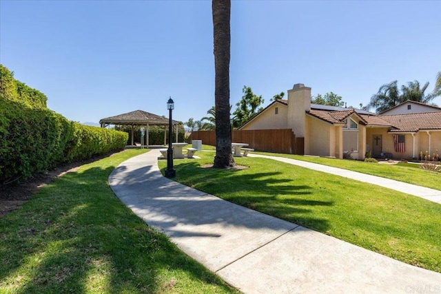 view of front facade with a gazebo and a front lawn