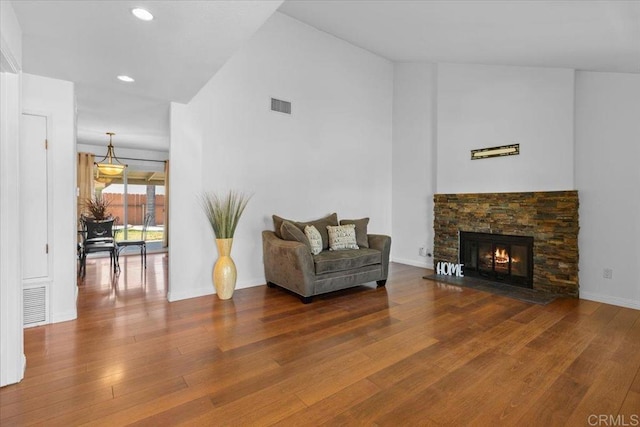 sitting room with wood-type flooring and a fireplace