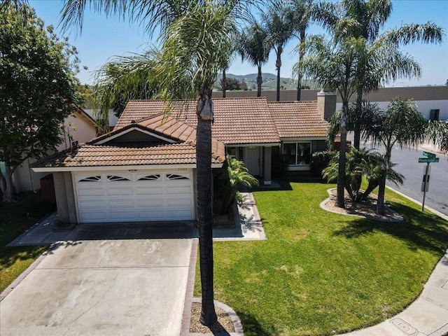 view of front facade with a front yard and a garage