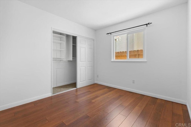 unfurnished bedroom with a closet and wood-type flooring