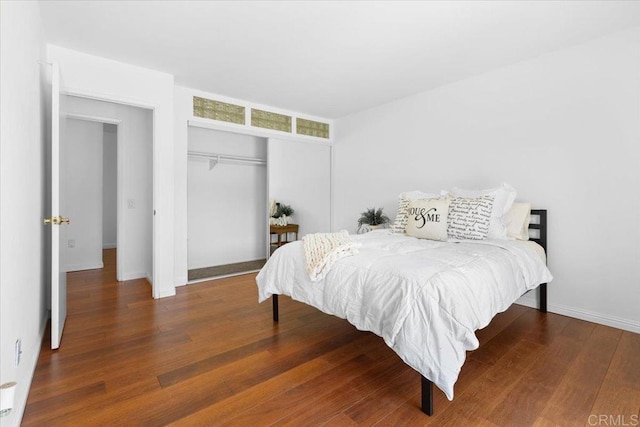 bedroom featuring dark hardwood / wood-style floors and a closet