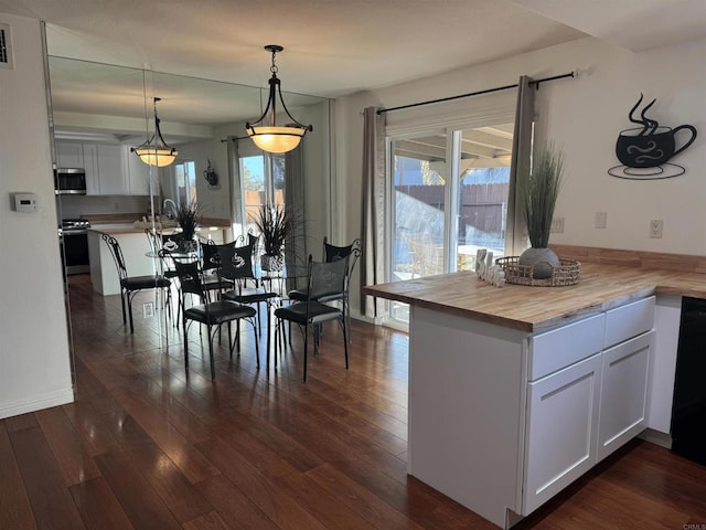 unfurnished dining area featuring dark hardwood / wood-style flooring