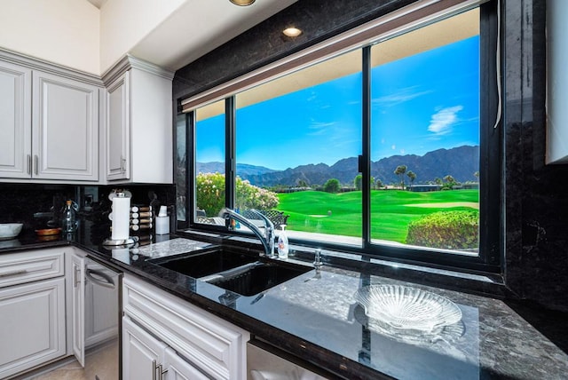 kitchen featuring sink, white cabinets, and a mountain view