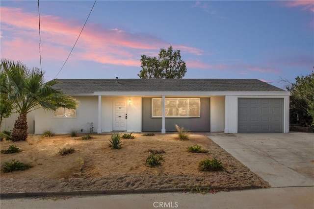 ranch-style home featuring a garage