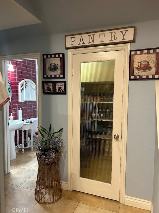 doorway to outside with light tile patterned flooring