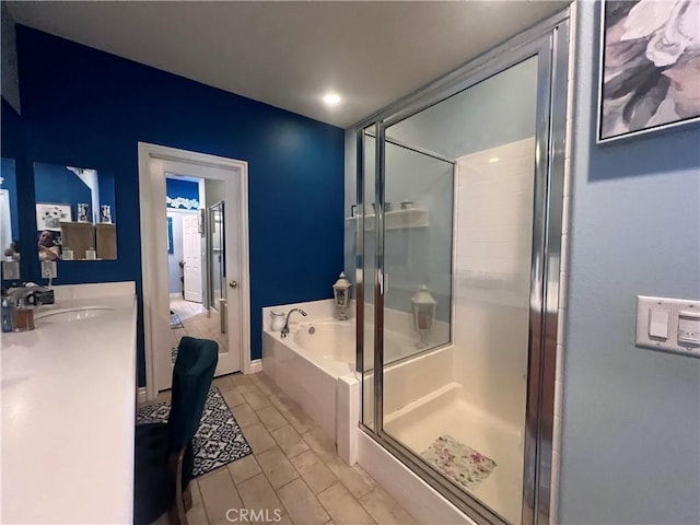 bathroom with tile patterned floors, separate shower and tub, and sink