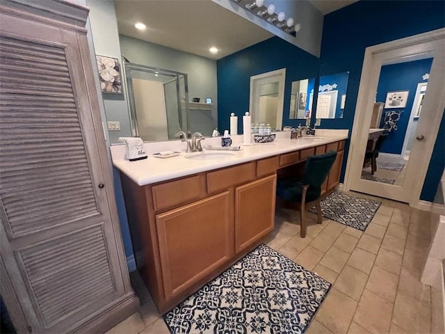 bathroom featuring tile patterned flooring, vanity, and a shower with shower door