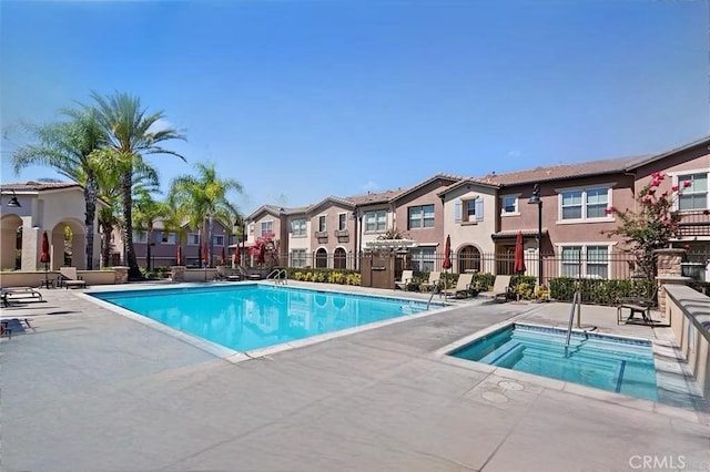 view of swimming pool featuring a community hot tub