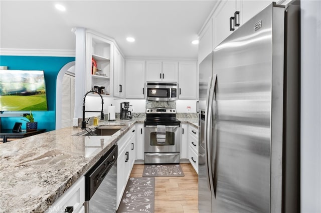 kitchen with white cabinetry, light stone countertops, sink, and appliances with stainless steel finishes