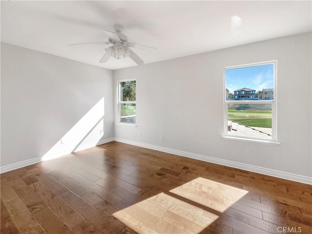 spare room featuring ceiling fan and dark wood-type flooring