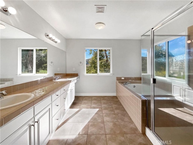 bathroom with tile patterned flooring, vanity, and plus walk in shower