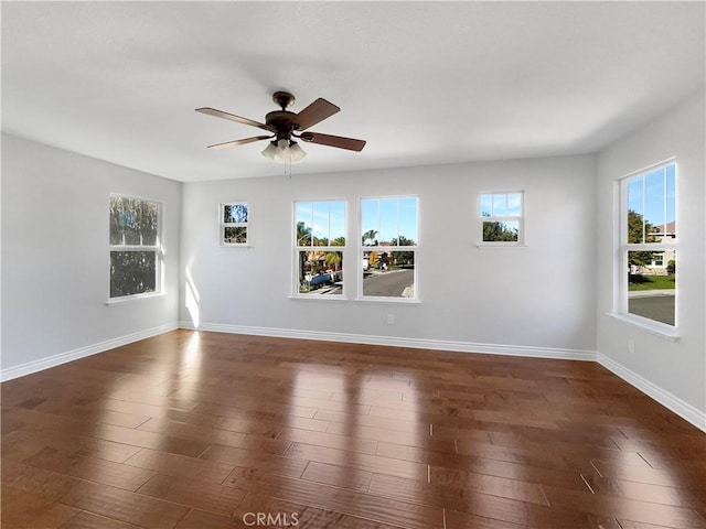 empty room featuring ceiling fan and dark wood-type flooring