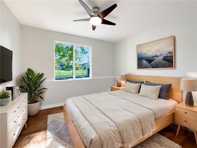 bedroom with ceiling fan and wood-type flooring