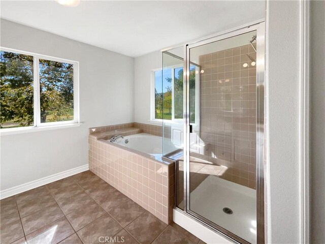 bathroom with tile patterned flooring, plenty of natural light, and plus walk in shower