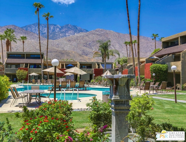 view of swimming pool with a mountain view and a patio