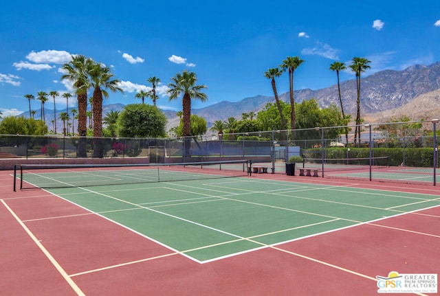 view of tennis court featuring a mountain view