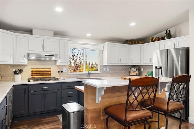 kitchen featuring stainless steel gas stovetop, white cabinetry, and sink