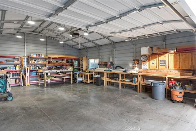 garage featuring a garage door opener and a workshop area