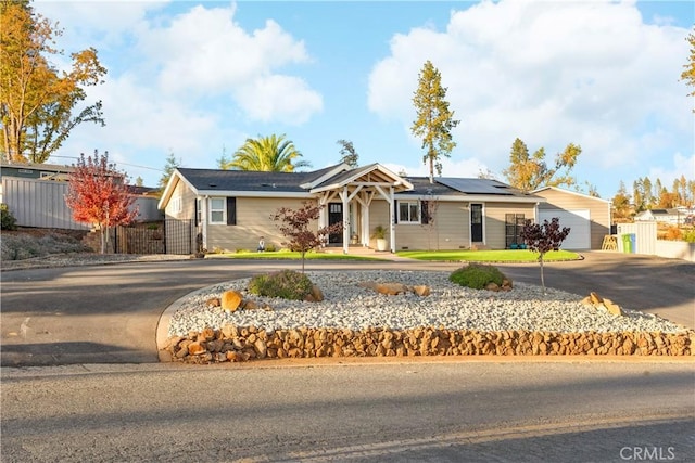 ranch-style house featuring solar panels