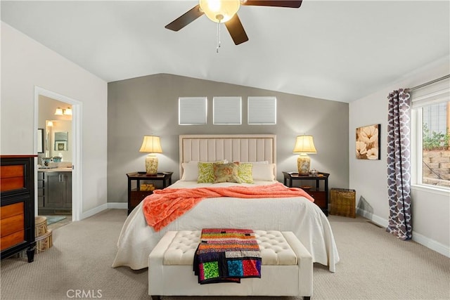 carpeted bedroom with ceiling fan, connected bathroom, and lofted ceiling