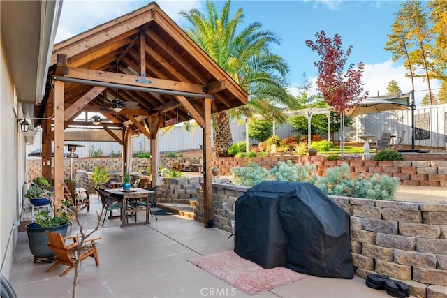 view of patio with ceiling fan, a gazebo, and a grill