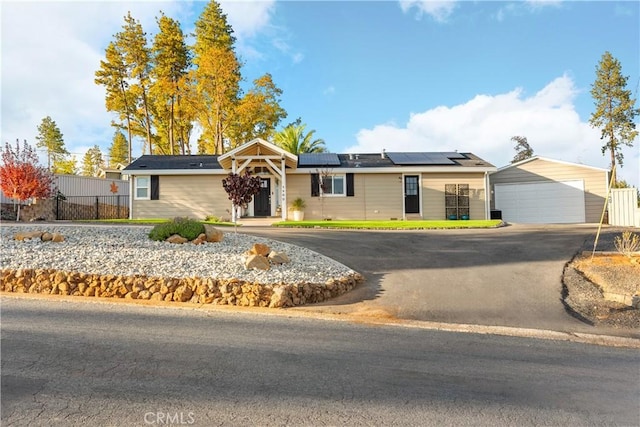 ranch-style house with solar panels and a garage