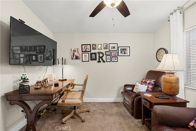 office space with light carpet and ceiling fan