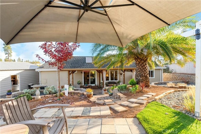 rear view of property featuring a patio area