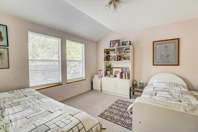 carpeted bedroom featuring lofted ceiling