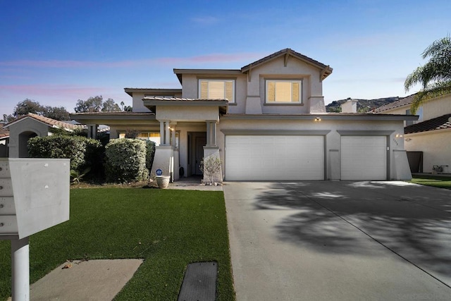 view of front of property featuring a yard and a garage