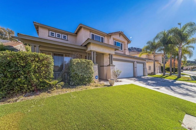 view of front of property featuring a garage and a front lawn