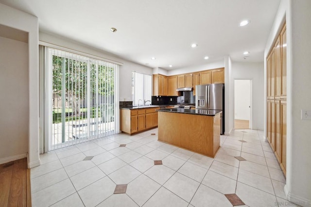 kitchen featuring tasteful backsplash, stainless steel fridge with ice dispenser, a center island, and light tile patterned floors