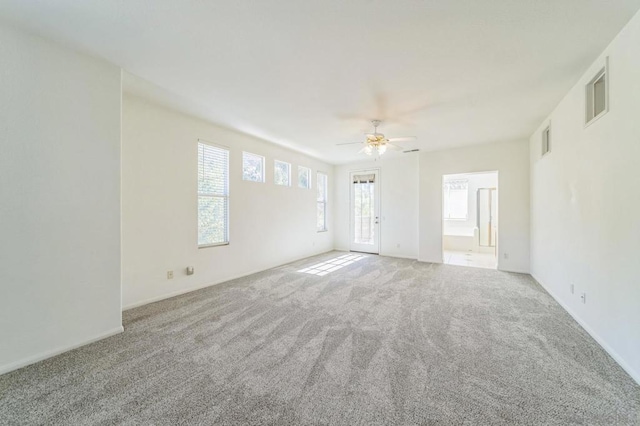 spare room featuring ceiling fan and light colored carpet