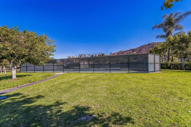 view of yard featuring tennis court and a mountain view