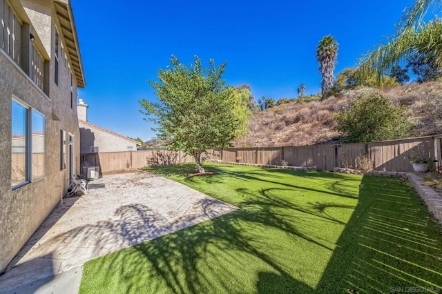 view of yard featuring a patio and central AC